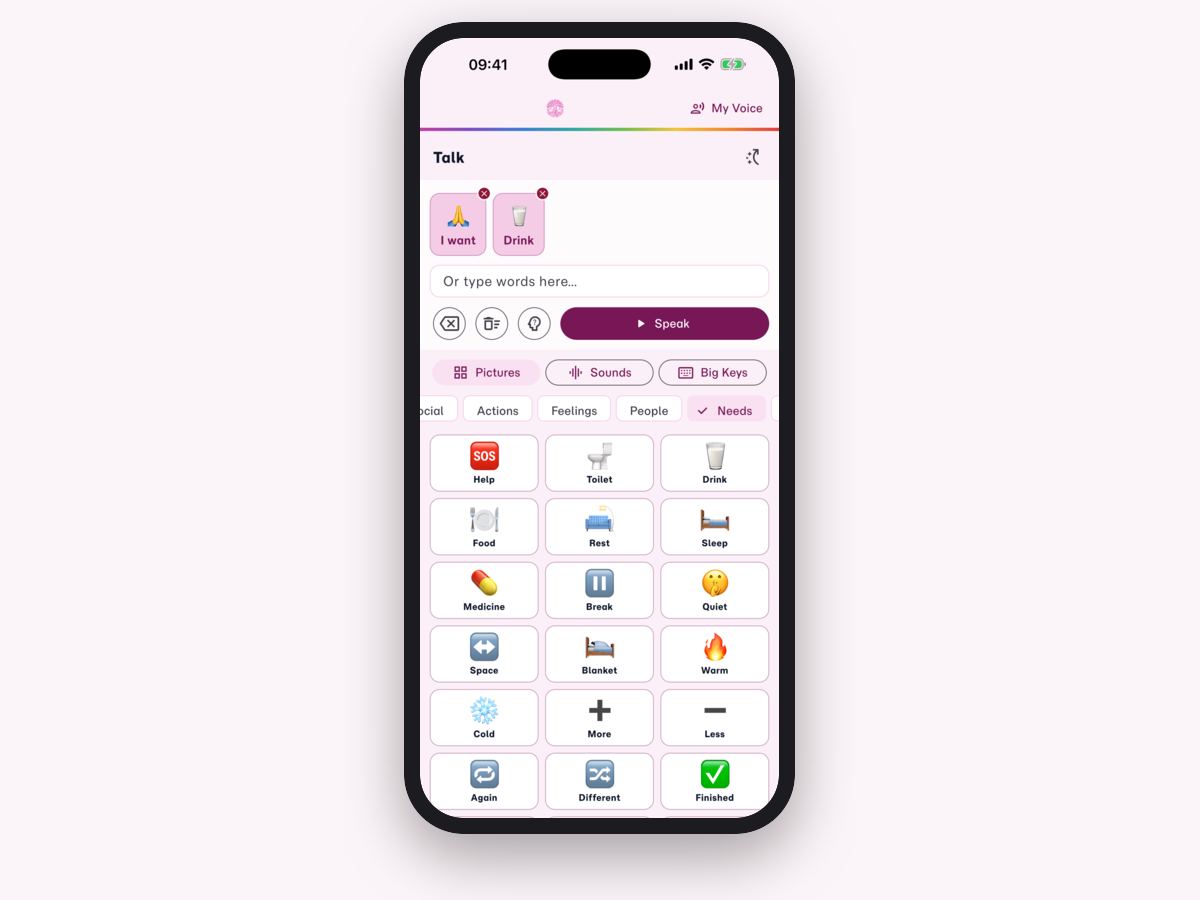 An iPhone showing the Talk symbol board, with I want and Drink in the sentence bar and a grid of Needs cards such as Help, Toilet, Drink and Food.